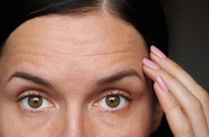 Woman Touching Forehead